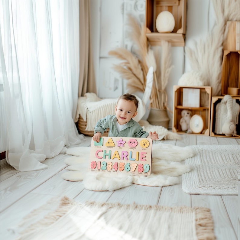 May include: A wooden puzzle with the name "CHARLIE" and numbers 0-9 in various colors. The puzzle has colorful shapes and is held by a smiling child. The background includes wooden crates and decorative elements.