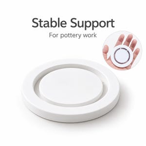 May include: A white circular pottery support stand with a raised center platform. The text Stable Support For pottery work is printed above the object. A circular inset shows the white circular object being held in a palm for scale.