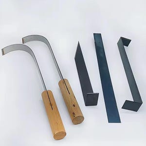 May include: Two metal tools with curved blades and cylindrical wooden handles, accompanied by three flat, dark metal components including one straight bar and two L-shaped brackets, all arranged on a plain white surface.