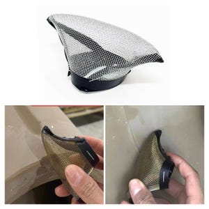 May include: A fencing mask with a silver mesh visor and a black leatherette base. The mask is designed to protect the face and head during fencing. The image shows the mask from multiple angles.