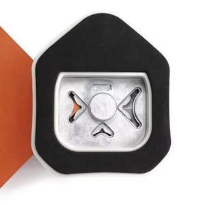 May include: Close-up of a silver-colored metal object with a black border. The object has a central circular element and three arrow-shaped cutouts. An orange corner is visible in the background.