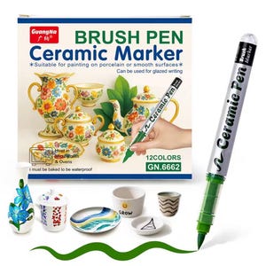 Puede incluir: Un juego de rotuladores cerámicos GuangNa en una caja con ilustraciones de porcelana floral. El envase incluye texto sobre pintura en superficies lisas y requisitos de calor. Un rotulador verde dibuja una línea ondulada.