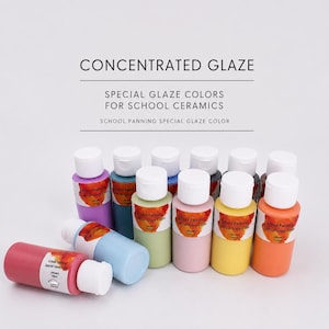 May include: A collection of 100ml bottles of concentrated glaze for school ceramics. Each bottle features a white cap and a label reading School Panning Special Glaze Color. The bottles are arranged in rows, displaying various colors including pink, blue, green, yellow, and orange.