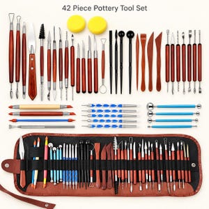 May include: A 42-piece pottery tool set featuring various wooden and metal sculpting implements, including loop tools, knives, ball styluses, and brushes. The set includes two yellow sponges and a brown roll-up storage case with black elastic loops.