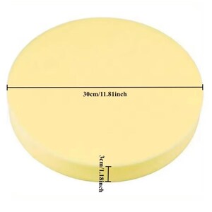 May include: A round, pale yellow cushion. The diameter is 30cm/11.81 inches, and the thickness is 3cm/1.18 inches. The cushion is a solid color and appears to be made of a soft material.