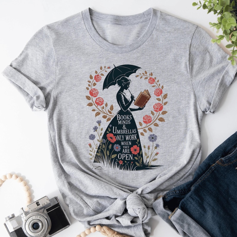 a t - shirt with a picture of a woman holding an umbrella