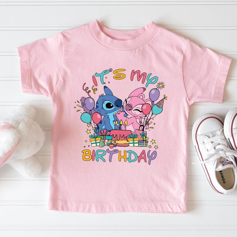 a pink t - shirt with a picture of a cartoon character on it