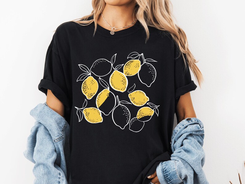 a woman wearing a black shirt with lemons on it