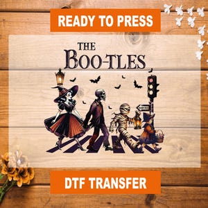 May include: A DTF transfer with a Halloween theme. The image features a parody of the Beatles' Abbey Road album cover, with spooky characters crossing a crosswalk. The text "READY TO PRESS" and "THE BOO-TLES" are visible.