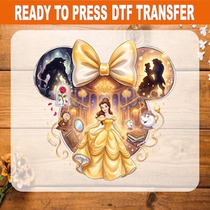 May include: A Ready to Press DTF transfer featuring a yellow bow above a central illustration of a woman in a yellow gown within a ballroom. Two circular frames show a dark creature and a dancing couple. Characters include a clock, teapot, and books.
