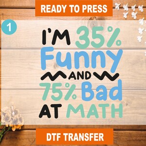 May include: A ready to press iron-on transfer design with the text "I'm 35% Funny and 75% Bad at Math" in black, blue, and green lettering on a wood background.