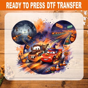 May include: A DTF transfer featuring a Mickey Mouse-shaped graphic with a Halloween theme. It depicts a brown tow truck and a red race car wearing a purple witch hat, surrounded by pumpkins, ghosts, and road signs on a watercolor background.