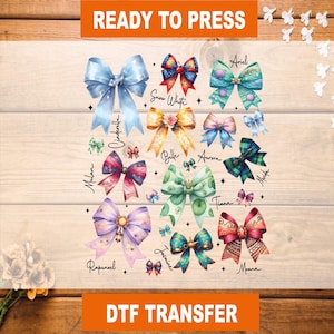 May include: DTF transfer sheet featuring colorful bows with character names like Ariel, Belle, and Moana. The bows are in various colors, including blue, pink, and green, with decorative elements. The text "READY TO PRESS" and "DTF TRANSFER" are at the top and bottom.