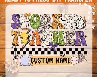 May include: A colorful DTF transfer design with the words "Spooky Teacher" in a playful font. The design includes Halloween-themed elements like ghosts, bats, and spiderwebs. A pencil graphic at the bottom has space for a custom name. The text "READY TO PRESS DTF TRANSFER" is at the top.