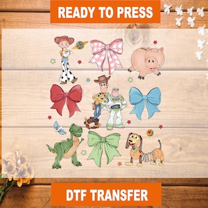 May include: Ready to Press DTF Transfer featuring characters from the Toy Story franchise.  The design includes Woody, Buzz Lightyear, Jessie, Rex, Slinky Dog, and a piggy bank.  There are also several bows in various colors.