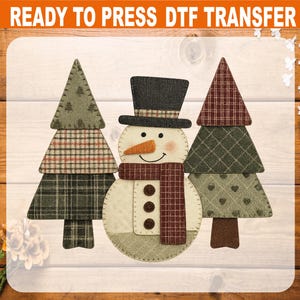 May include: A snowman and two Christmas trees DTF transfer. The snowman has a black top hat, orange carrot nose, and a red and brown scarf. The trees have green and brown plaid and patterned designs. The text "READY TO PRESS DTF TRANSFER" is at the top.