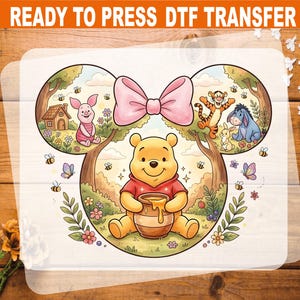 May include: A DTF transfer featuring Winnie the Pooh and friends. The design includes Winnie the Pooh holding a honey pot, Piglet, Tigger, Eeyore, and a pink bow. The text "READY TO PRESS DTF TRANSFER" is at the top.