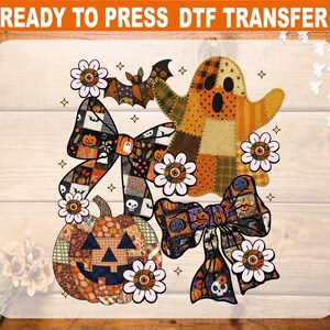 May include: A Halloween-themed DTF transfer design featuring a patchwork ghost, pumpkin, and bows. The design includes floral accents, a bat, and stars. The text "READY TO PRESS DTF TRANSFER" is at the top.