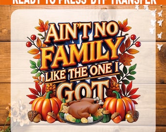 May include: A DTF transfer design with the text "AIN'T NO FAMILY LIKE THE ONE I GOT" in a 3D style. The design includes pumpkins, a roasted turkey, acorns, and fall leaves, perfect for Thanksgiving.