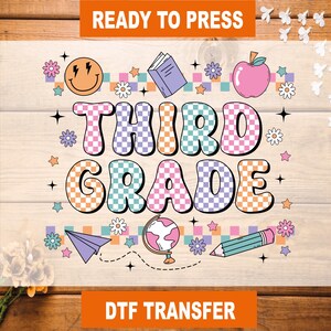 May include: A colorful DTF transfer design with the words "THIRD GRADE" in a checkered pattern. The design includes a smiley face, flowers, an apple, a book, a globe, a pencil, and a paper airplane. The text "READY TO PRESS" and "DTF TRANSFER" are also included.