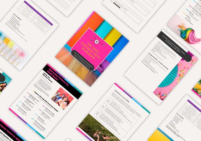 Puede incluir: Una vista cenital de varios papeles blancos y un cuaderno de trabajo. El cuaderno, titulado "The ADHD Dopamine Menu Workbook", est&aacute; centrado, con una portada rosa y un fondo colorido. Otros papeles presentan texto e im&aacute;genes, con bordes coloridos.