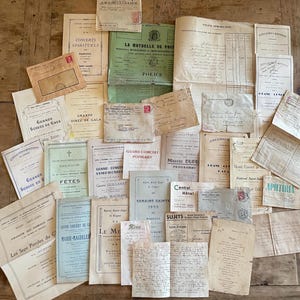 May include: A collection of vintage French paper ephemera including concert programmes, handwritten letters, envelopes with stamps, and official documents. The assortment features various typography, ink colours, and paper textures in cream, white, and green.