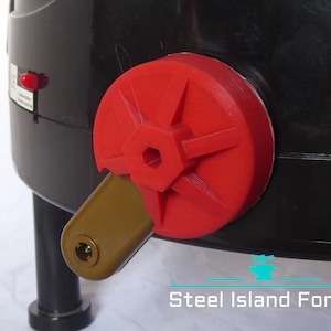 May include: A red plastic valve with a hexagonal opening and a brown plastic lever. The valve is attached to a black plastic container.