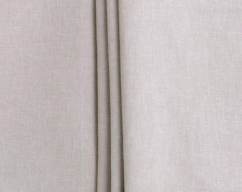May include: Close-up of a light gray fabric with a subtle texture. The fabric is folded in three places, creating a smooth, even surface.