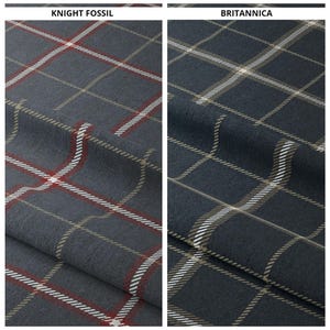 May include: Two fabric swatches with a plaid pattern. The swatch on the left is labeled "Knight Fossil" and has a dark blue background with red, white, and tan plaid. The swatch on the right is labeled "Britannica" and has a dark blue background with white and tan plaid.