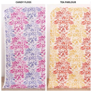May include: Two vertical fabric panels featuring a repeating damask pattern. The left panel, labeled CANDY FLOSS, displays pink and purple motifs on a white background. The right panel, labeled TEA PARLOUR, shows orange and yellow motifs on white.