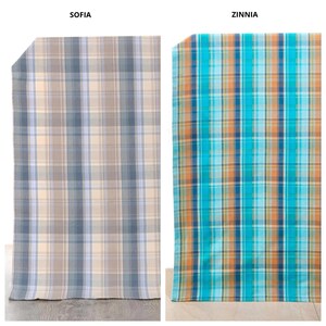 May include: Two rectangular fabric swatches labeled Sofia and Zinnia. The Sofia swatch features a plaid pattern in shades of light blue, gray, and cream. The Zinnia swatch displays a vibrant plaid pattern in bright turquoise, orange, and dark blue.