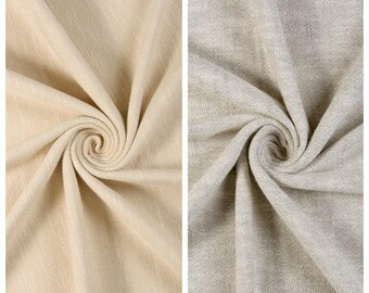 May include: Two fabric swatches, one in a light beige color labeled "MORNING HAZE" and the other in a light gray color labeled "CRESCENT MOON." Both fabrics are swirled to show texture and drape.