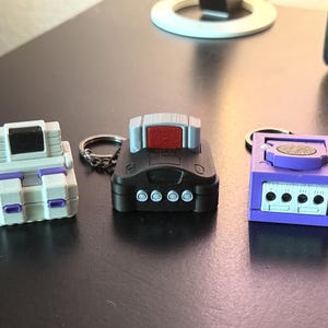 Retro Console Clicker Keychains Inspired by Old School Nintendo Consoles