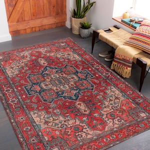 May include: A red, blue, and cream colored rug with a traditional Persian design. The rug has a central medallion and intricate floral patterns.