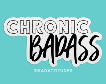 May include: A white sticker with the words "CHRONIC BADASS" in a bold, outlined font and a cursive font. The sticker has a light blue background and the text "@BADATTITUDES" at the bottom.
