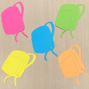 May include: Five paper cutouts of backpacks in different colors: pink, green, blue, yellow, and orange. Each cutout has a simple design with a single pocket and a stitched detail.
