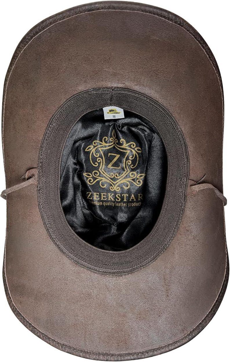 Pode incluir: Chap&eacute;u de couro castanho com aba larga, visto por dentro. O interior apresenta um forro de cetim preto com o logotipo "ZEEKSTAR" e um emblema dourado. O chap&eacute;u &eacute; de tamanho m&eacute;dio.