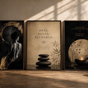May include: A set of three rectangular wall art prints in black frames. The left print shows a person's back with gold brushstrokes and text. The centre print features stacked stones and text. The right print displays a moon, plants, and text.