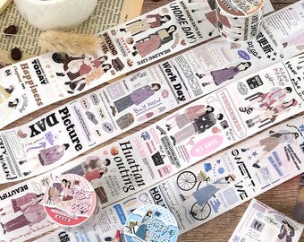 May include: Decorative washi tape rolls and strips with various designs. The tape features illustrations of people, text, and patterns in pastel colors. The rolls are in pink, blue, and brown. The theme is journaling and scrapbooking.