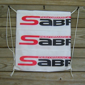 May include: White drawstring bag with three red and black "PERFORMANCE SABF" logos printed on it.
