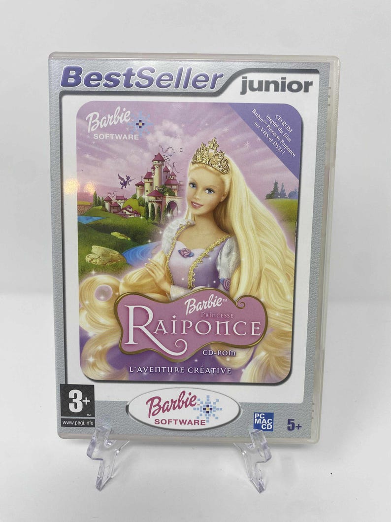 May include: A Barbie Princess Rapunzel CD-ROM game in a clear plastic case. The cover shows Barbie as Rapunzel with long blonde hair, a tiara, and a castle background. The game is rated for ages 3+.
