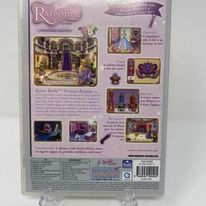 May include: A Barbie Raiponce CD-ROM game case. The back of the case features images of a princess, a castle, and various decorative elements. Text includes "Rejoins Barbie Princesse Raiponce" and "Transforme le ch&acirc;teau".