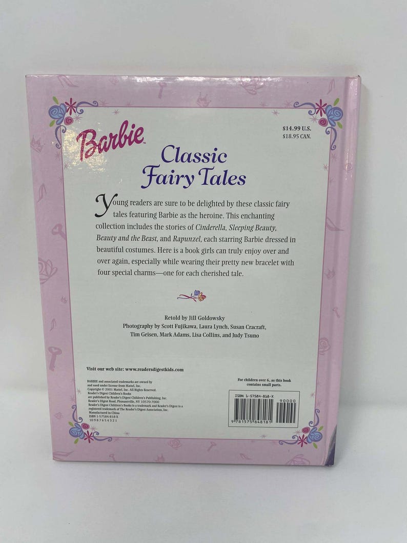 May include: A pink Barbie book titled "Classic Fairy Tales." The cover features the Barbie logo and floral designs. The book includes stories of Cinderella, Sleeping Beauty, Beauty and the Beast, and Rapunzel.