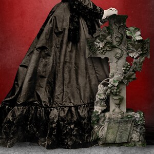 May include: A vintage-style image featuring a person in a long black dress with a decorative cross. The cross is made of stone, adorned with grape vines and leaves, and has a weathered appearance. The background is a deep red.