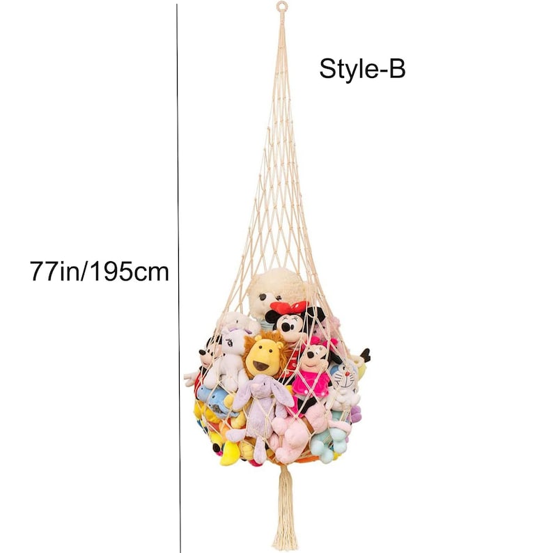 May include: A beige macrame hanging toy storage net, Style-B, filled with various plush toys. The net is 77 inches (195cm) long, with a tassel at the bottom. The toys include a teddy bear, Mickey Mouse, and other colorful stuffed animals.