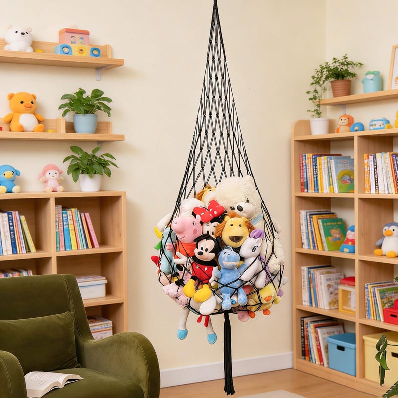 May include: A black mesh hanging storage net filled with various plush toys. The net is suspended from the ceiling, creating a space-saving solution for organizing stuffed animals. The toys are a mix of colors and characters.