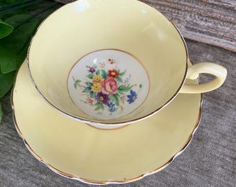 Tuscan fine China Teacup and Saucer: yellow with colourful floral design. Made in England