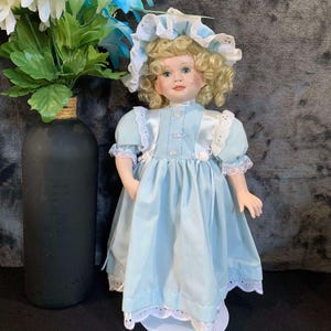 Elizabeth and her bear, Porcelain Doll 13 inches tall.  Paradise Galleries Treasury, includes bear