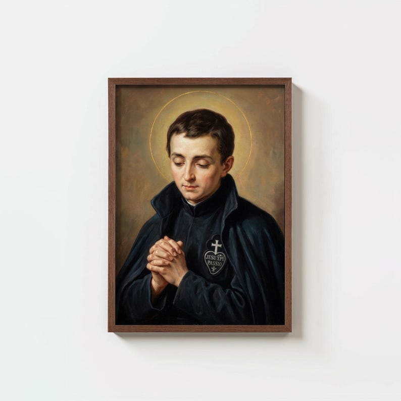 May include: A framed portrait of a man in a dark blue coat, hands clasped in prayer. A gold halo surrounds his head. The portrait features a cross emblem on the coat.