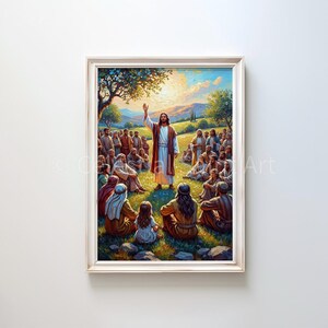 May include: A framed painting depicts a religious scene with a central figure in a white robe and red cloak, raising his hand. A crowd of people sits on the grass, listening. The artwork is set in a sunny outdoor environment.